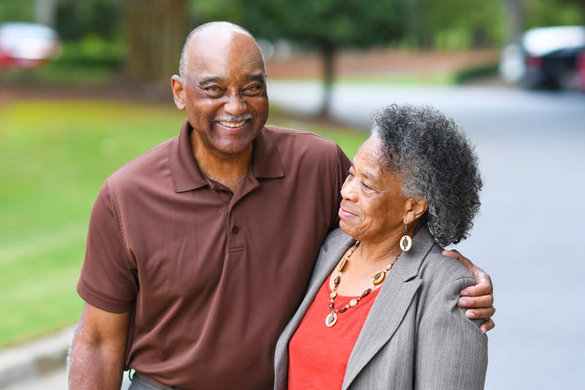Senior couple living at Traditions of Zanesville enjoying a walk on the paved community walking paths